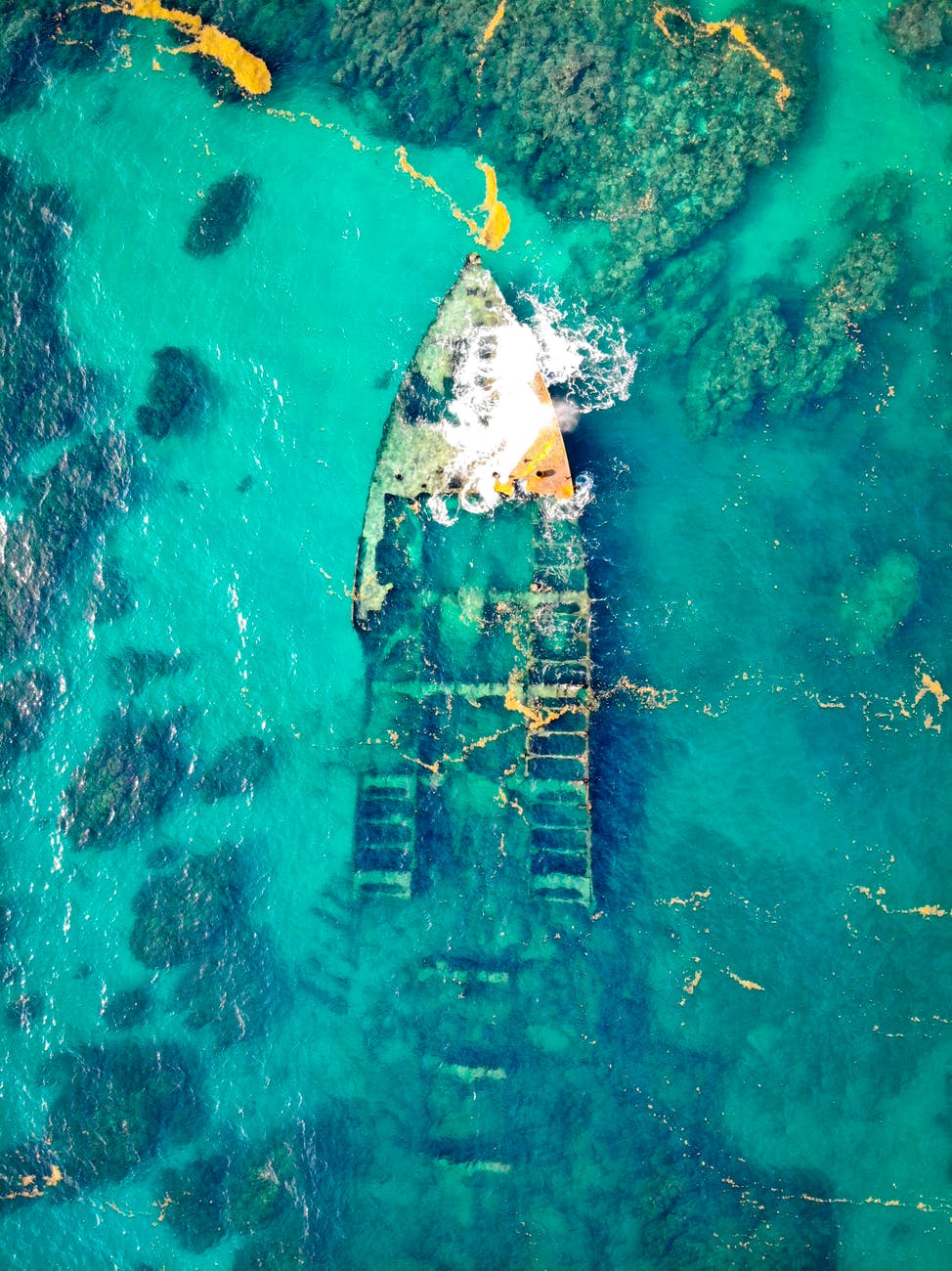 aerial view of a ship wreck on body of water